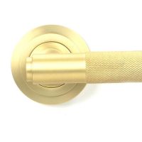 Close-Up of Satin Brass "Royale" Unsprung Art-Deco Door Handle on Rose Set