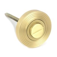 Close-Up of Satin Brass Beehive "Vienna" Round Bathroom Thumb Lock - Set in Situ