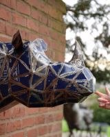 ‘Azure’ the Rhino Head Mount Wall Art mounted on brick wall side image with hand in shot for scale