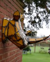 ‘Volt’ the Rhino Head Mount Wall Art mounted on brick wall side profile image with hand to give sense of scale