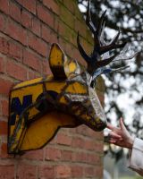‘Glint’ the Stag Head Mount Wall Art mounted on brick wall side profile with hand in shot for scale