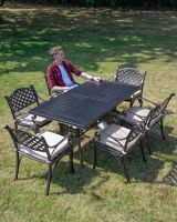 The "St. Regis" 6-Seater Outdoor Dining Set - Antique Copper Scale Shot With A Man The "St. Regis" 6-Seater Outdoor Dining Set - Antique Copper Scale Shot With A Man