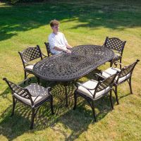 The "Valeriana" 6-Seater Outdoor Dining Set - Antique Copper Scale Shot In A Garden