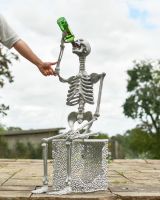 Scale image of silver skeleton garden sculpture