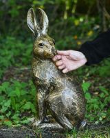 Scale image of gold rabbit garden sculpture