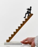 Scale image of cast aluminium person and mango wood stairs 