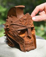 Scale image of rusted gladiator skull garden ornament