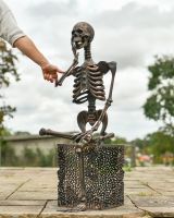 Scale image of skeleton outdoor sculpture