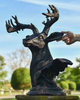 scale view of antique bronze stag bust 