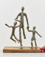 scale image of father and children indoor art sculpture