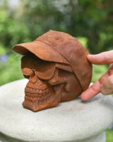 scale image of skull patio sculpture