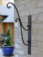 Scrolled Hanging Basket Bracket on a Grey Wall Scrolled Hanging Basket Bracket on a Grey Wall