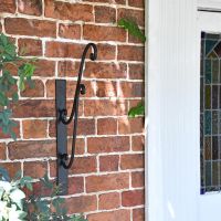 Black Scrolled Hanging Basket Bracket in Situ Net to the Front Door Black Scrolled Hanging Basket Bracket in Situ Net to the Front Door