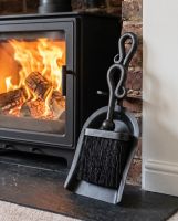 The "Malvern" Brush and Pan Set next to a Lit Log Burner Stove Against the Fireplace - Digital Illustration 