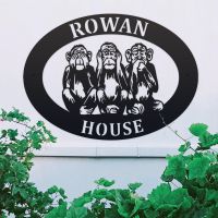 "See No Evil, Hear No Evil, Speak No Evil" Iron Oval House Sign on a White Wall