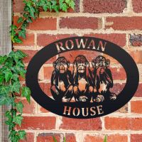 "See No Evil, Hear No Evil, Speak No Evil" Iron Oval House Sign on a Brick Wall