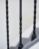 Close-Up of Set of 2 Matte Black "Enfield" Steel Stair Spindles - Pattern 12 in Situ