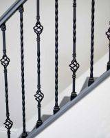 Close-Up of Set of 2 Matte Black "Enfield" Steel Stair Spindles - Pattern 14 in Situ