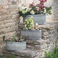 Set of 3 Ribbed Steel Traditional Oval Planters in Situ