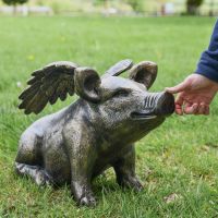 Brushed Gold Flying Pig with Hand for Scale  Brushed Gold Flying Pig with Hand for Scale