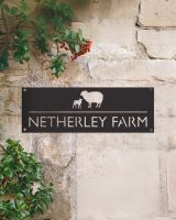 Sheep & Lamb Steel House Name Sign on a Rustic Sandstone Wall