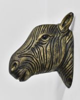 side view of black and gold animal wall bust
