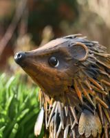 Close up of intricate face detail on handpainted garden sculpture Close up of intricate face detail on handpainted garden sculpture