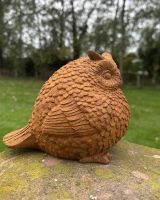Side view of rustic finish owl garden sculpture