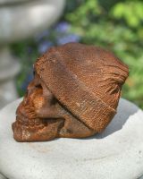 side view of rustic finish skull garden ornament