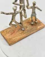 close up of mango wood base on father and children art sculpture
