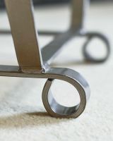 Close-Up of Arched Feet Design on Simplistic Antique Pewter Finish Log Holder