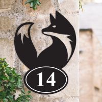 Simplistic Fox Iron House Number Sign on a Garden Wall