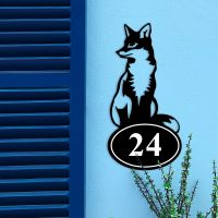 Sitting Fox Iron House Number Sign on a Blue Wall