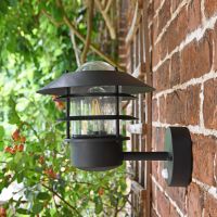Side View of the "Skive" Black Contemporary Wall Light Mounted on a Brick Wall