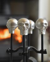 Close up of silver skull detail on fireside companion set