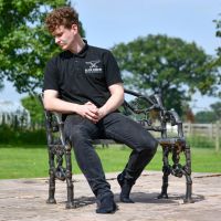 Aged Black Cast Iron Garden Bench with Male for Scale
