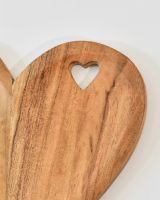 Close up of cut out heart detail on wooden heart serving platter