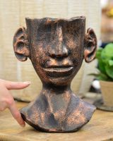 ‘The Watcher’ Contemporary Tribal Planter in Cast Aluminium Large with flowers with hand in shot for scale