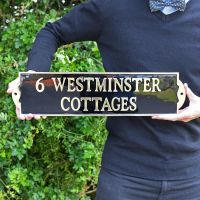 Large Black and Brass House Name sign in hands Large Black and Brass House Name sign in hands