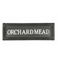 Black rectangular house sign with white letters Black rectangular house sign with white letters