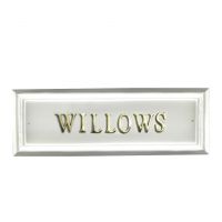 White rectangular house sign with Brass letters