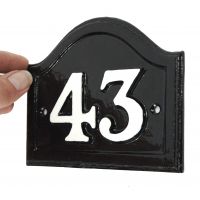scale image of black and white cast Iron arched house number plaque