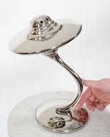 "Drift" UFO Nickel Plated Home Ornament with hand in shot for scale
