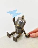 "Sprocket" the Upcycled Metal Home Ornament blue with hand in shot for scale