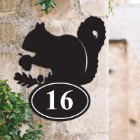 Squirrel Iron House Number Sign on a Garden Wall