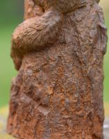 Close-up of Rustic Cast Iron Squirrel on Log Sculpture Close-up of Rustic Cast Iron Squirrel on Log Sculpture