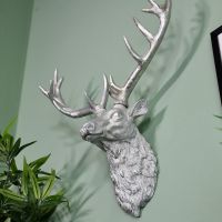 Stag Silver Head Wall Bust on a Green Wall