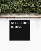 Steel Square House Name Sign In Situ on a White Garden Wall