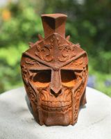 front view of rusted gladiator skull garden ornament