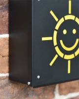 Close Up Of Sun Design On Post Box 